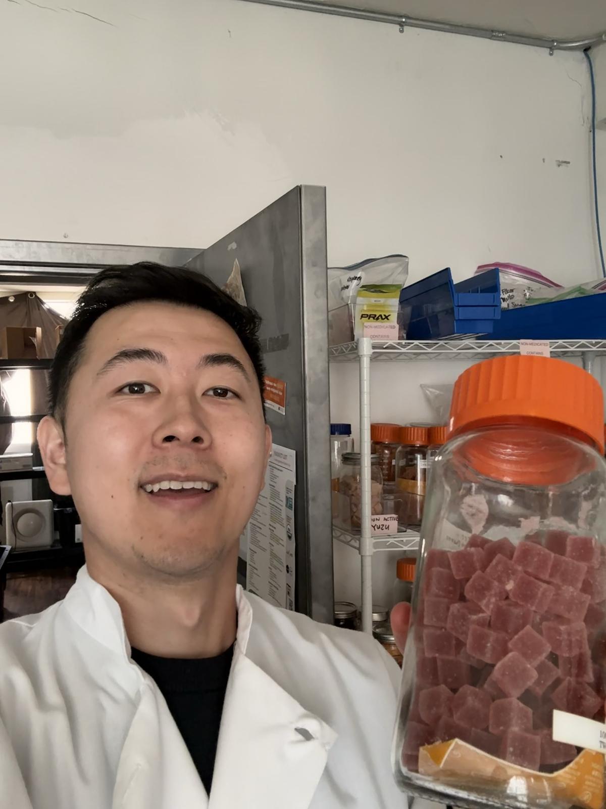Me in the lab holding a jar of our gummies